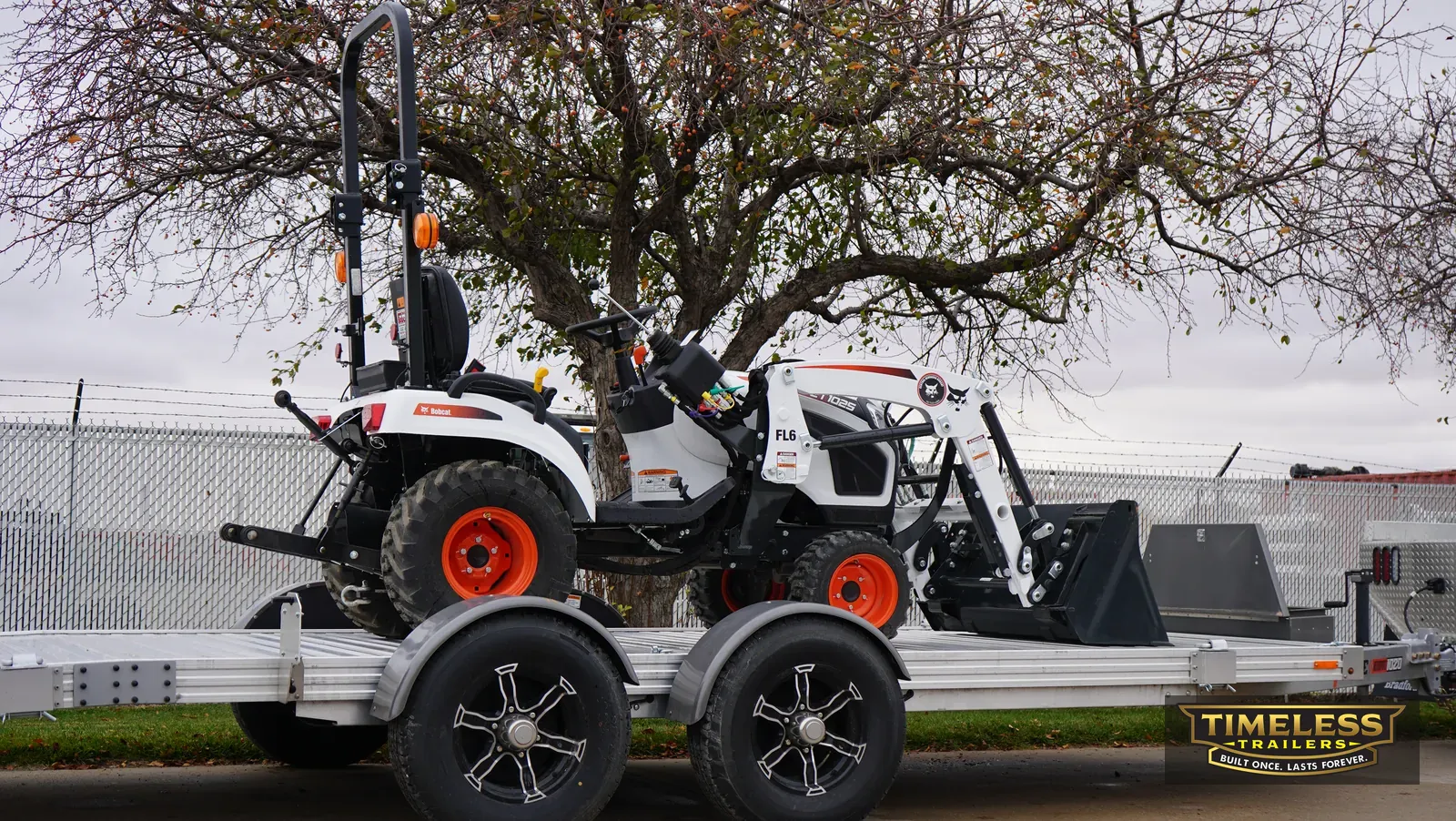 Timpte 1020 EZ Load with a compact tractor and loader on the deck