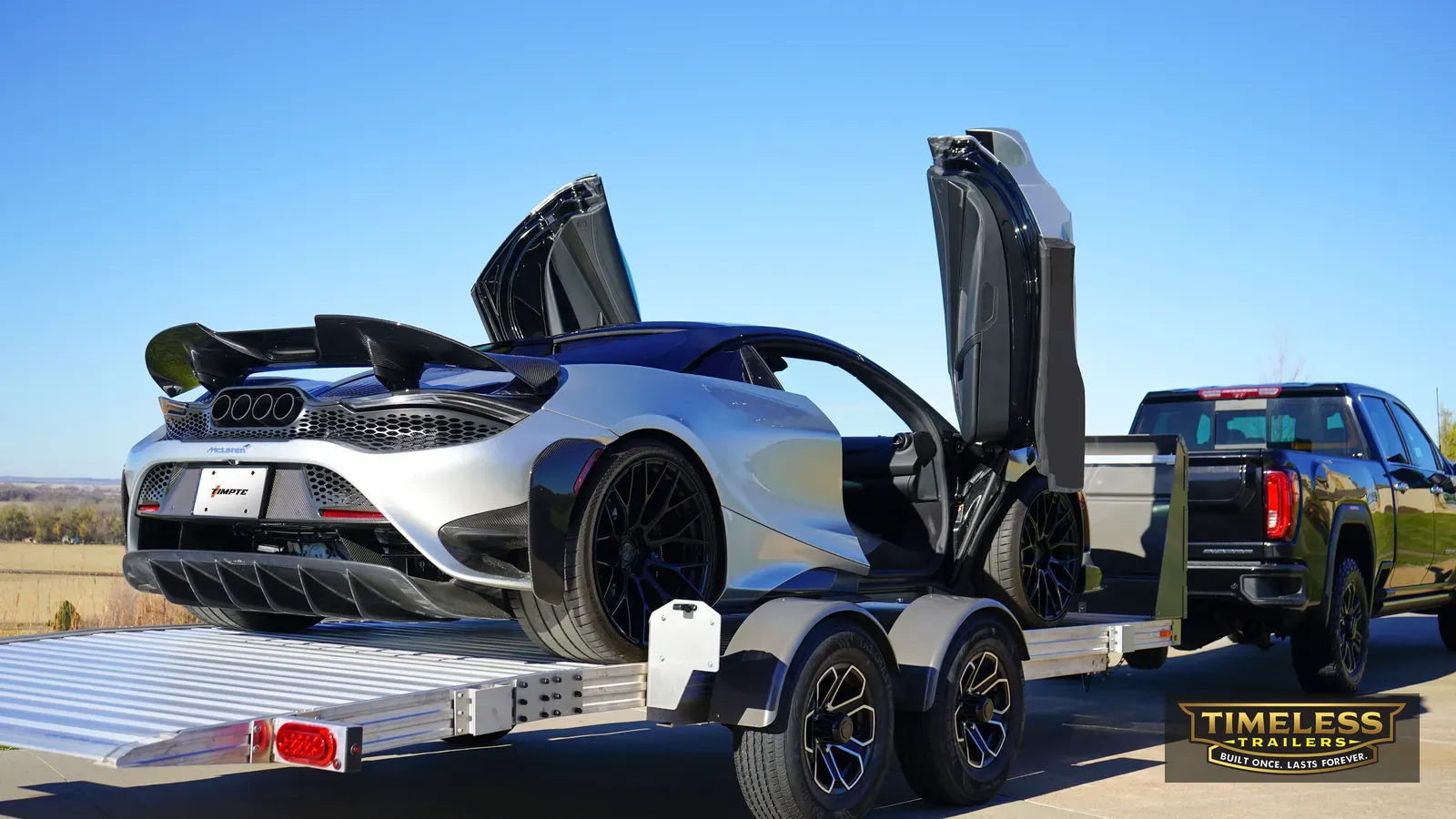 Timpte 1020 EZ Load with an exotic sports car, doors up, deck lowered