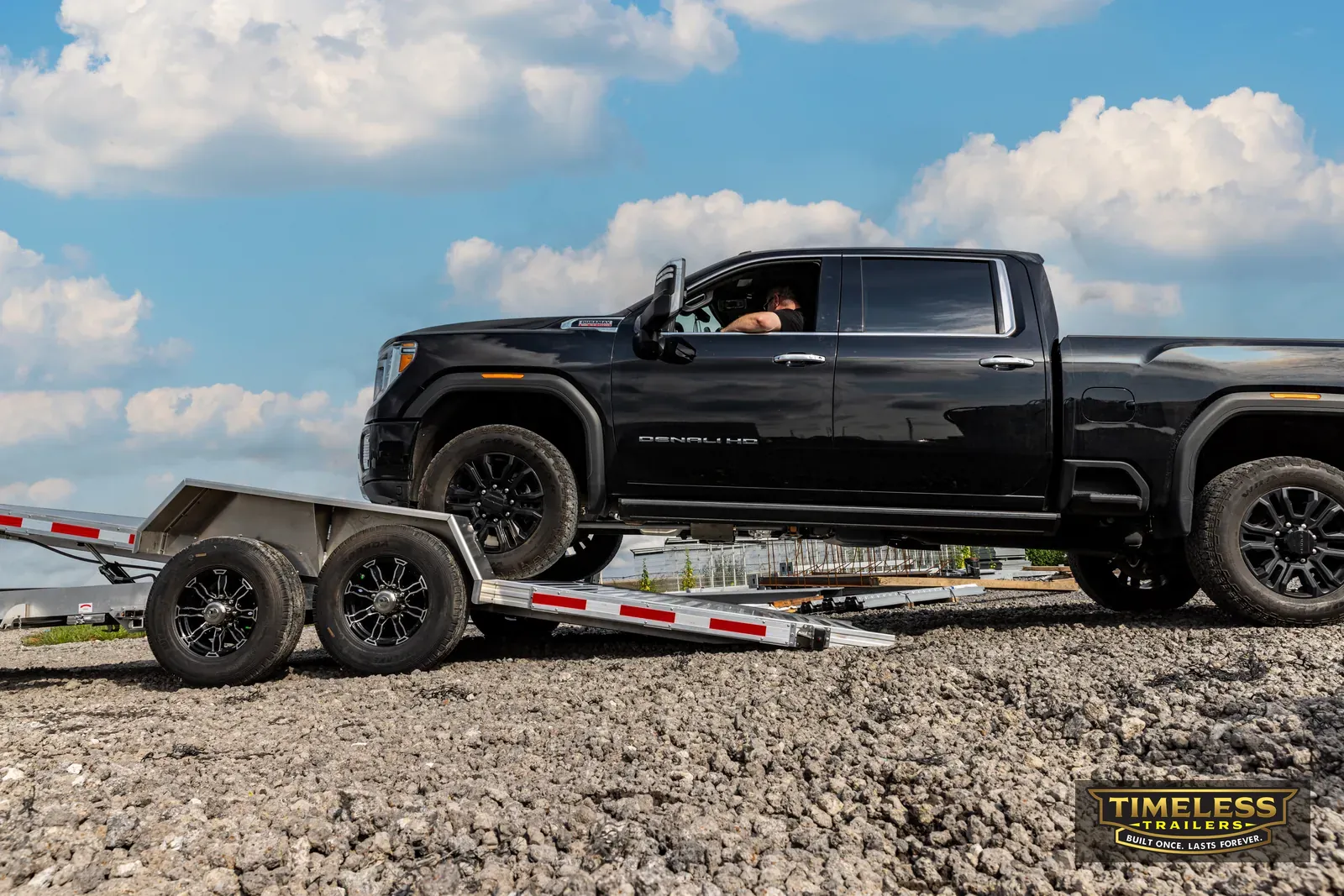 Timpte 1420 Split Tilt hitched to a black pickup, tilt deck down to the ground