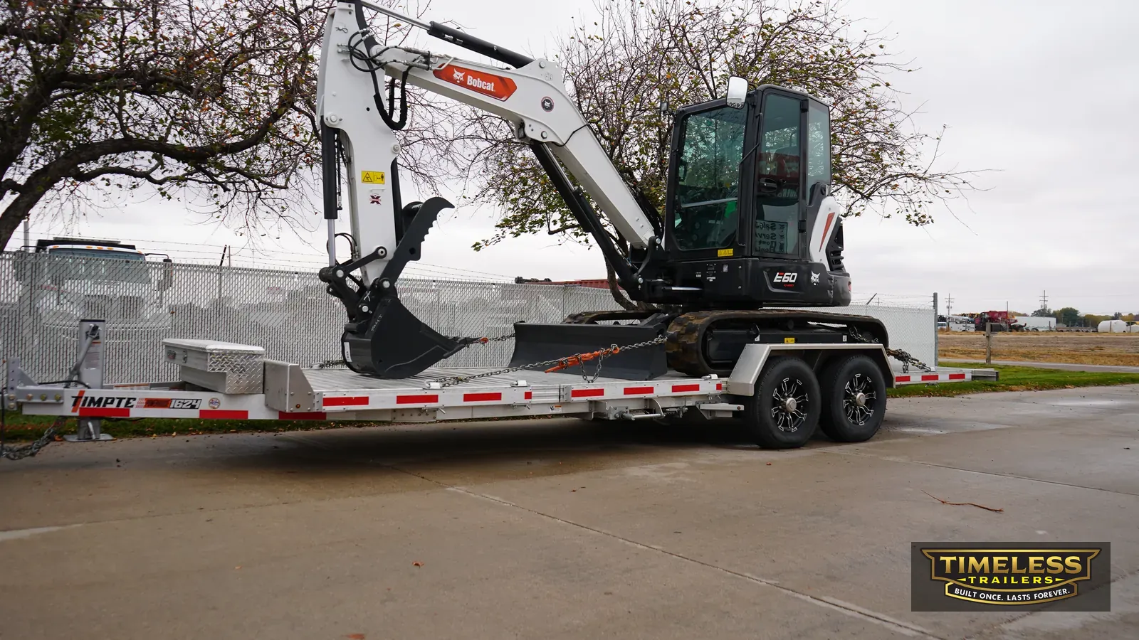 Timpte 1624 Split Tilt carrying a Bobcat mini excavator
