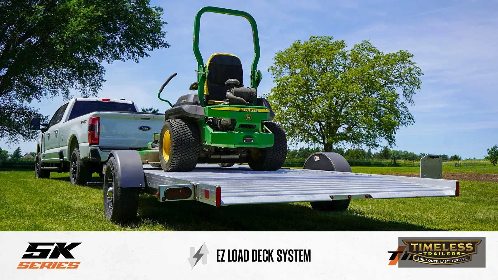Timpte 514 EZ Load carrying a zero-turn mower behind a pickup