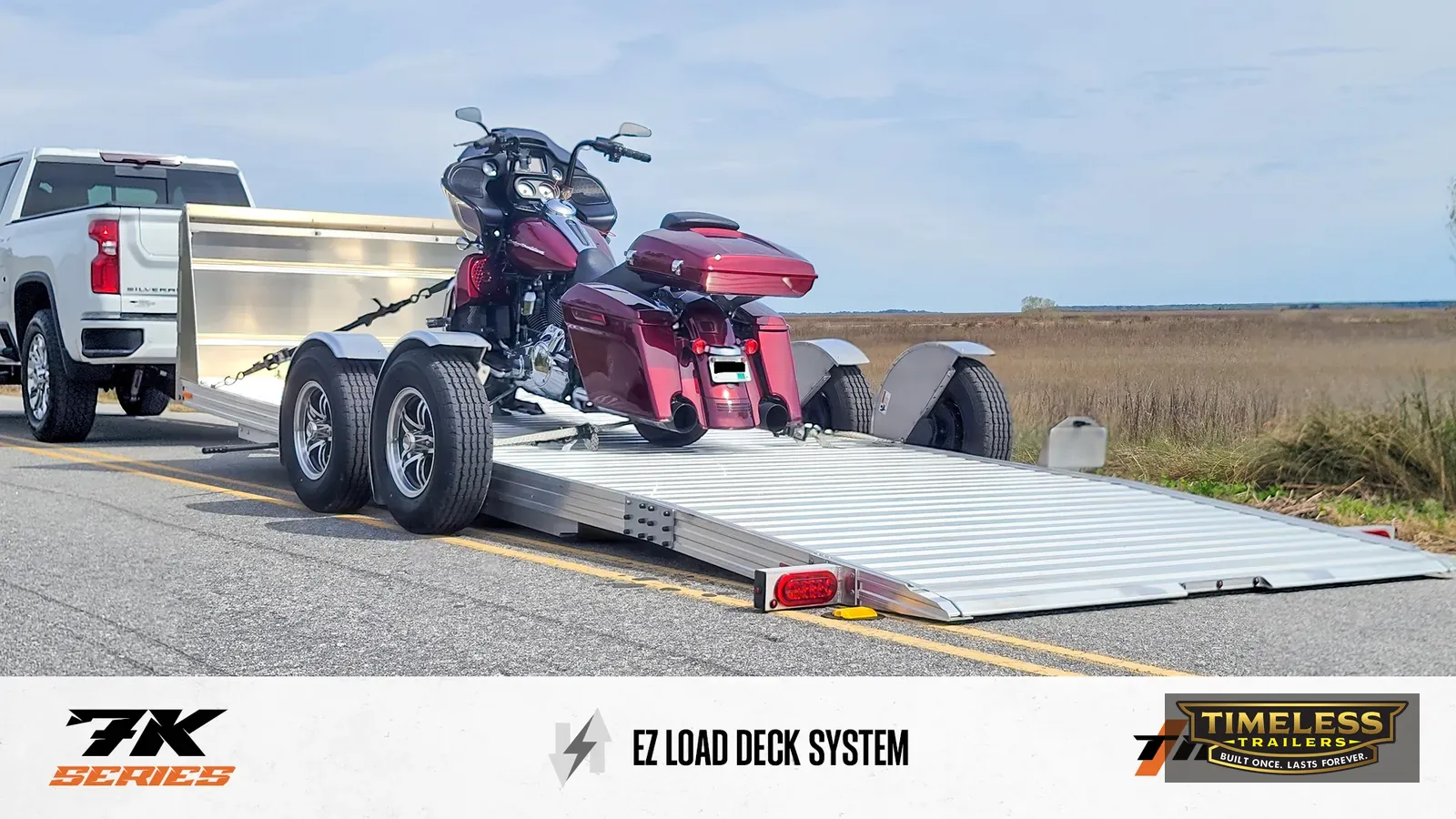 Timpte 720 EZ Load with a touring motorcycle, deck lowered to the ground