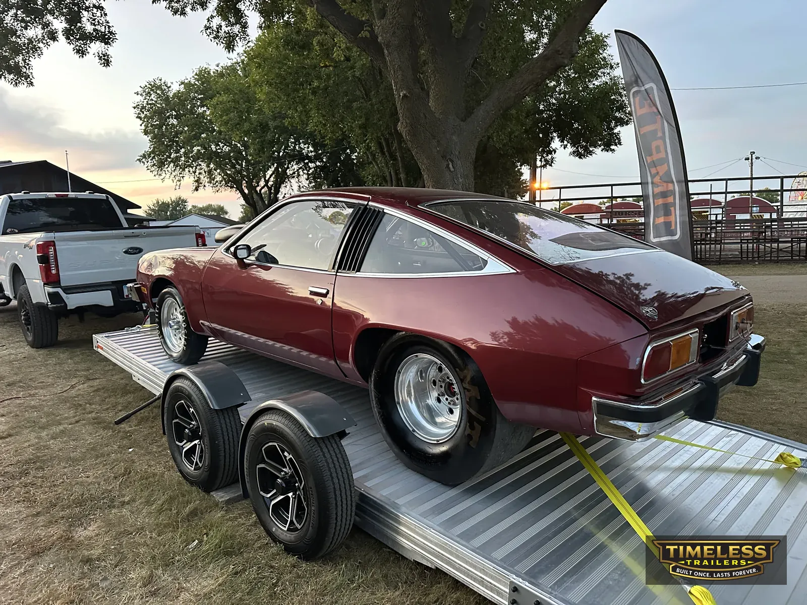 Timpte 720 EZ Load with a classic muscle car, deck tilted at a car show